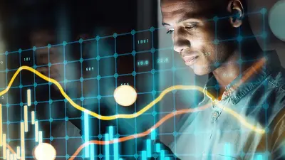 A man looks at a glowing, transparent stock market chart showing graphs and data, superimposed over his image.