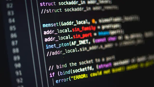 A close-up shot of multi-colored computer programming code on a dark screen, with line numbers on the left.