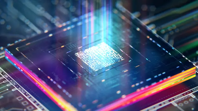 A futuristic, artistic rendering of a computer processor on a circuit board, with glowing blue light shooting up from its core.