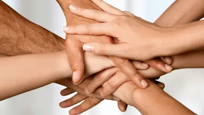 Hands stacked together.
